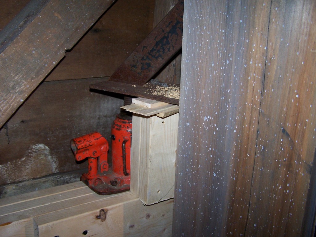 Jack and bracket supporting belfry post while bed timber is replaced Jack and bracket supporting belfry post while bed timber is replaced